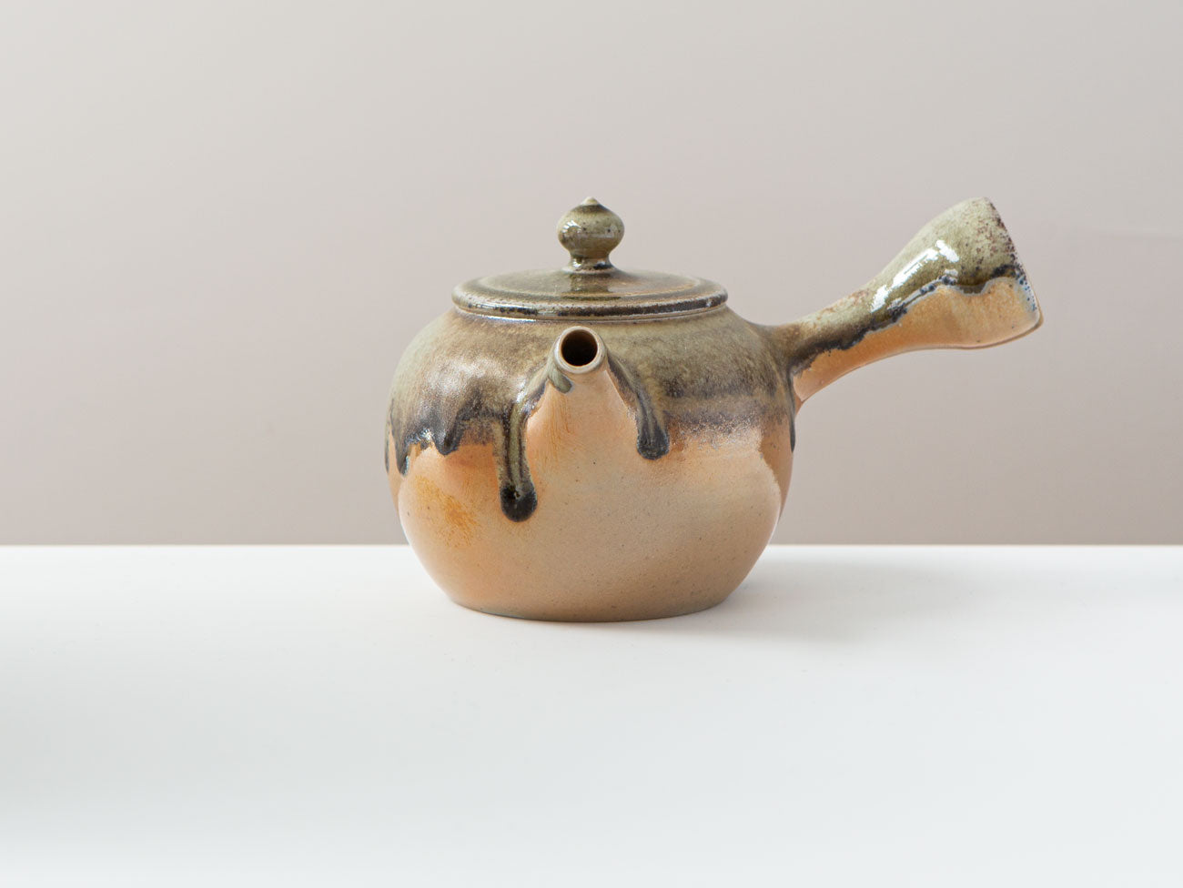 Ink + Gold. Front view. showing glaze drips around the spout.