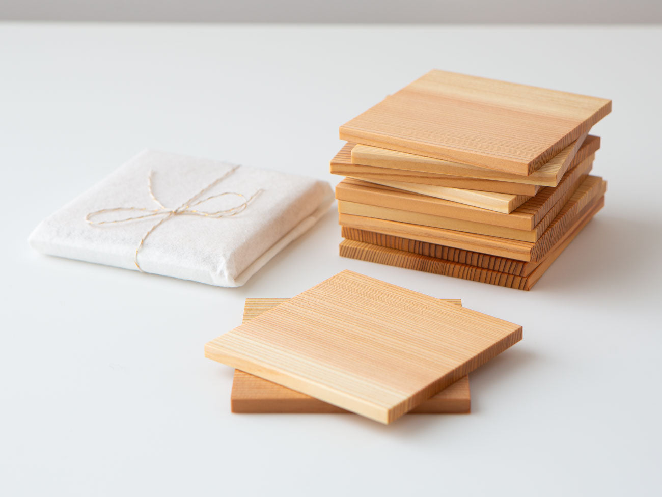 A pair of white cedar tea coasters.