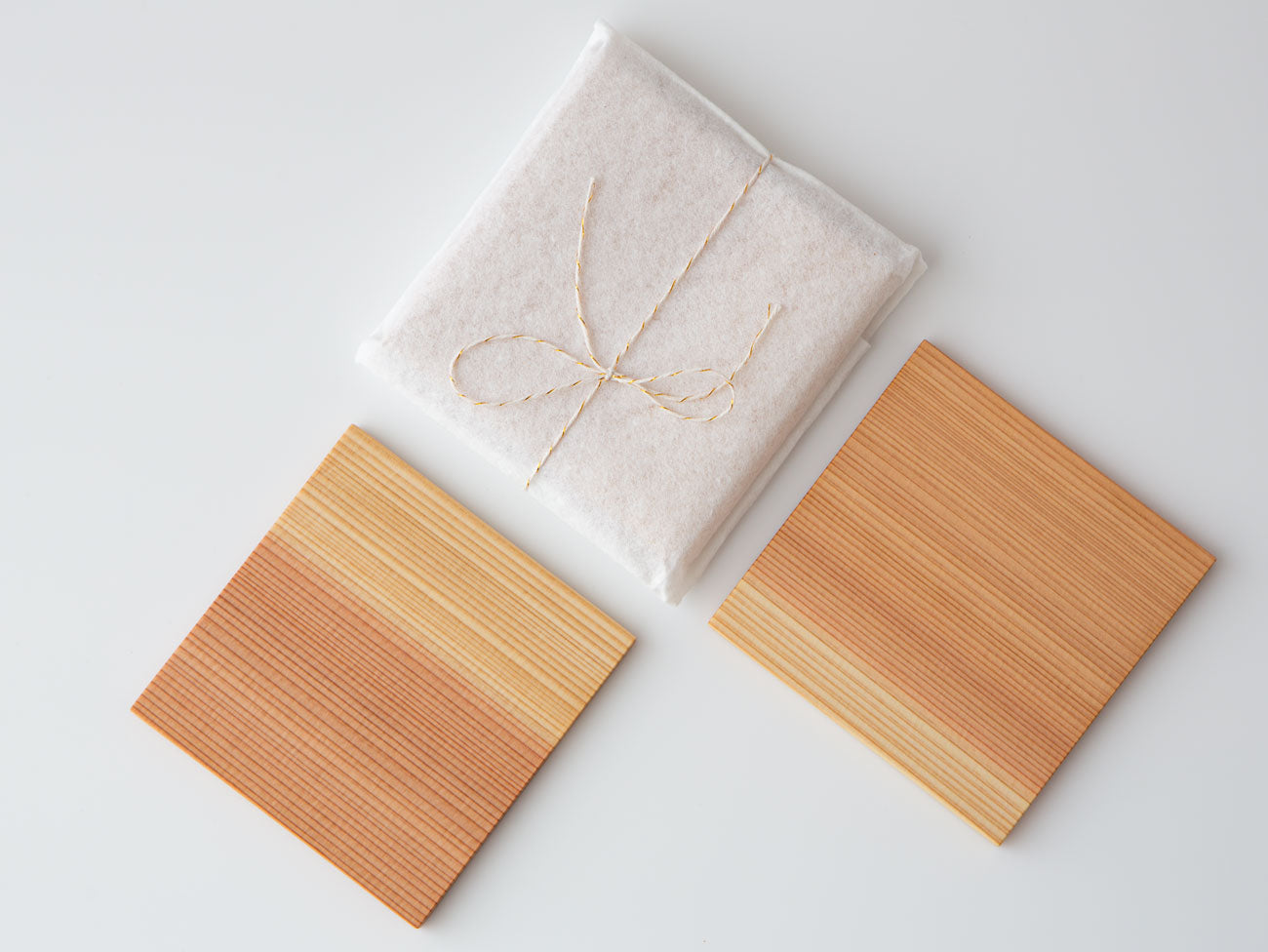 A pair of white cedar tea coasters.