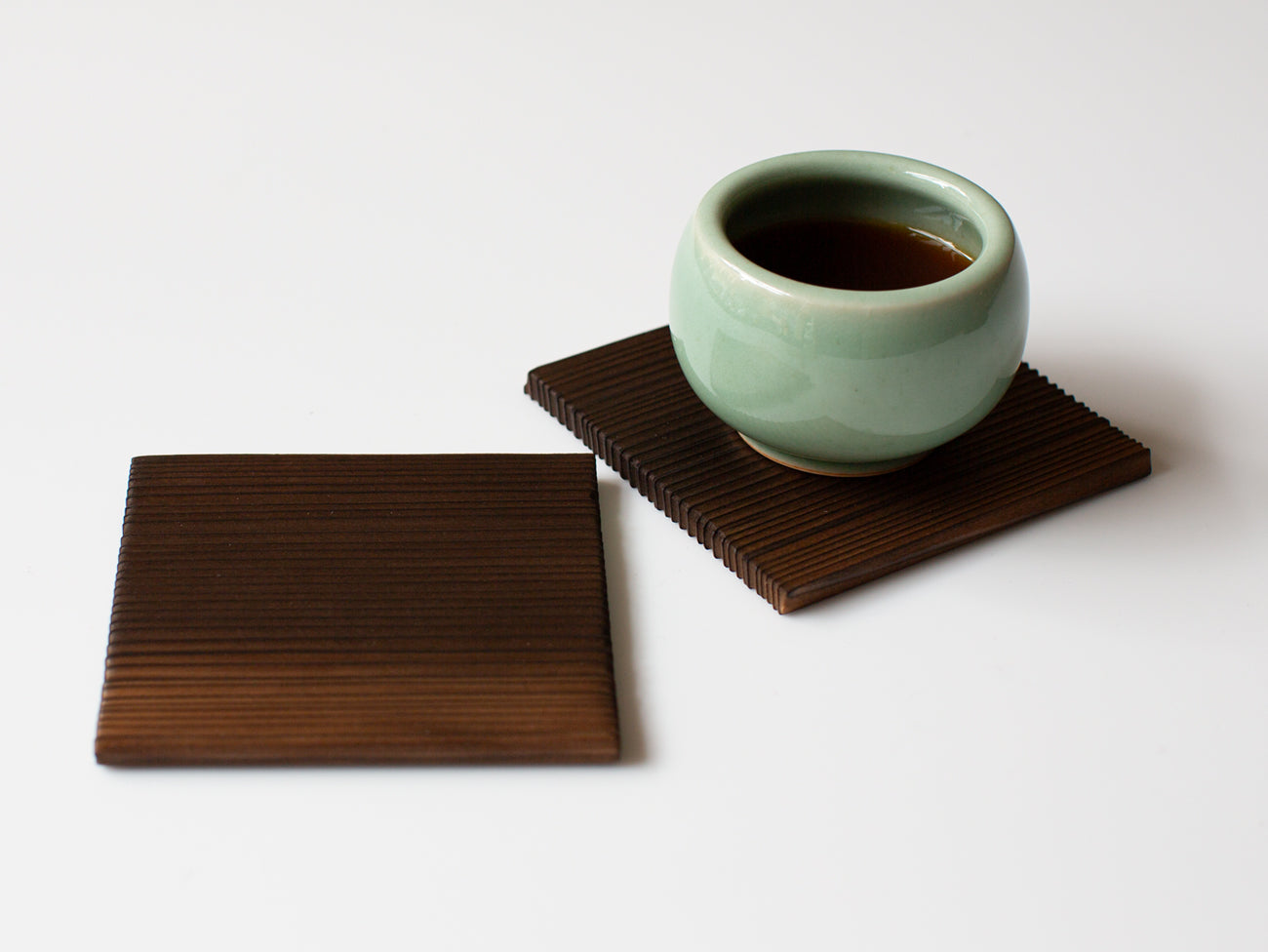 A pair of burnt cedar coasters.