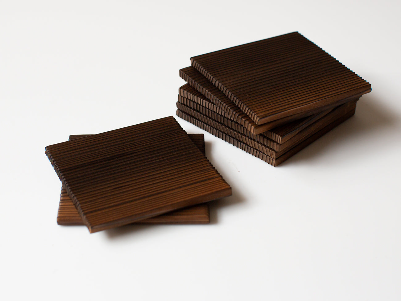 A pair of burnt cedar coasters.