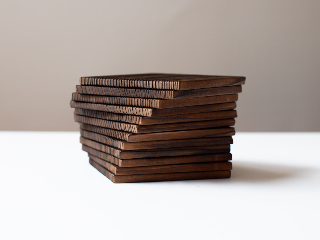 A pair of burnt cedar coasters.