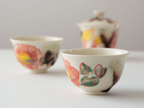 Hand-painted porcelain tea cups by Erin Louis Clancy.