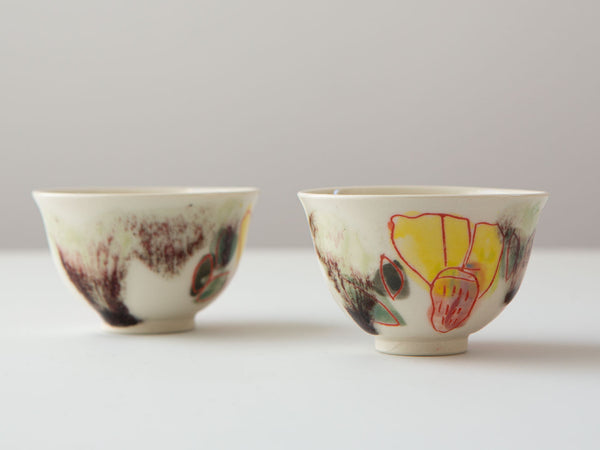 Hand-painted porcelain tea cups by Erin Louis Clancy.