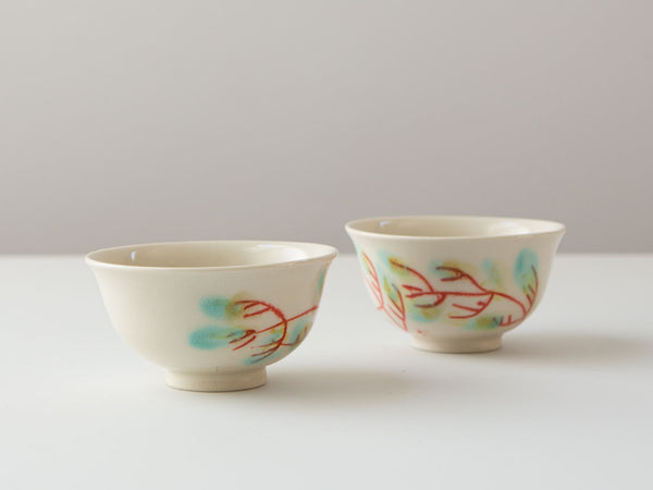 Hand-painted porcelain tea cups by Erin Louis Clancy.