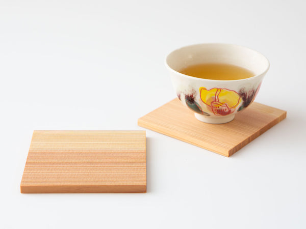 A pair of white cedar tea coasters.